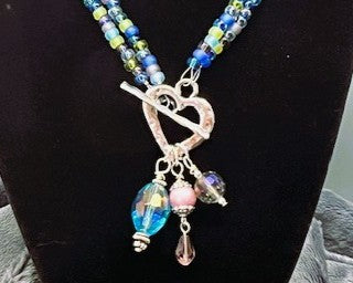 Necklace Heart Toggle Clasp with colorful beads and charms added on a black background