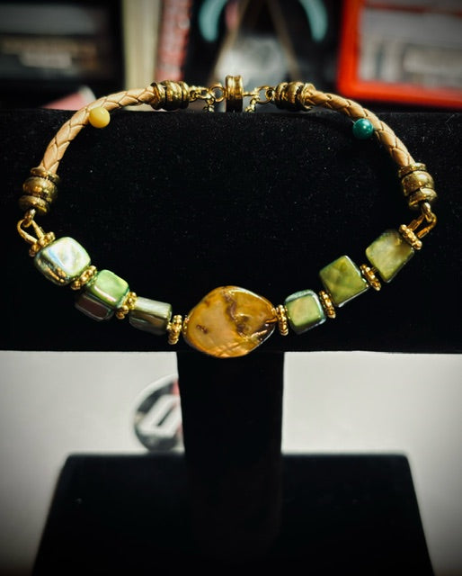 BR-0053 Glossy Golden Mother of Pearl and Pine Green Shell Beads on a Gold Braided Leather Band